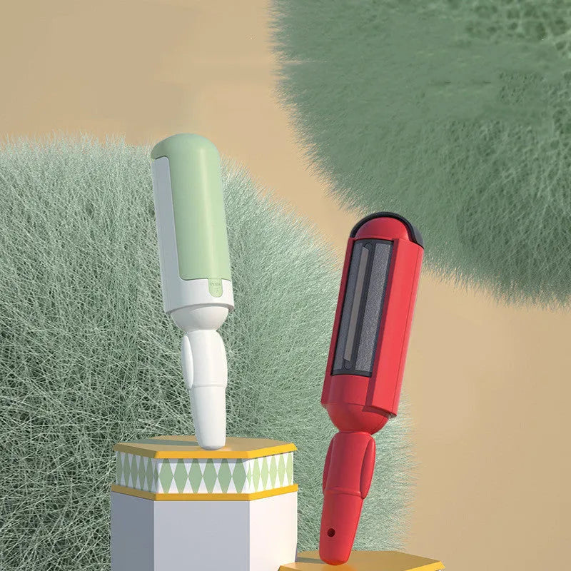 White and green reusable pet hair remover roller with a non-slip handle on a fabric sofa.