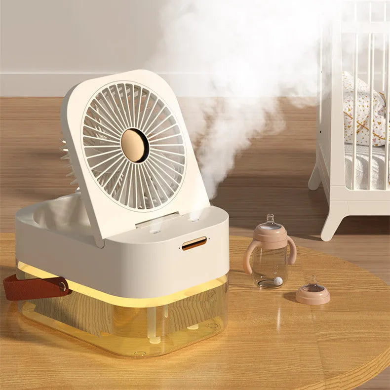 White desktop mist fan with humidifier tank and remote control on a wooden desk.