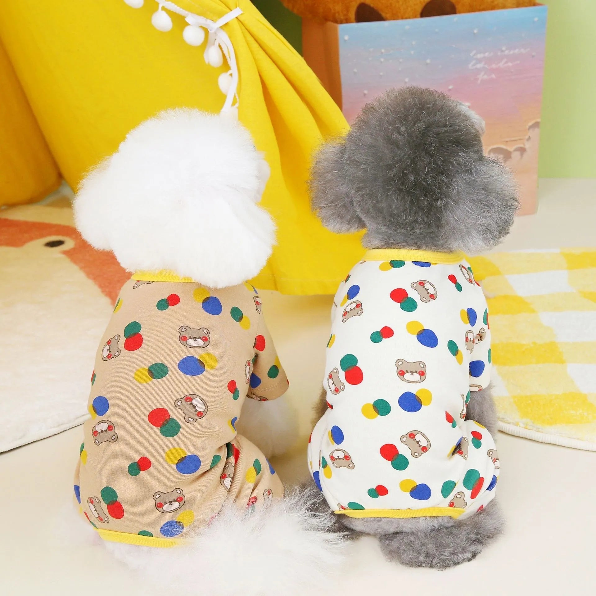 Beige dog jumper with colourful ball bear print, shown on a dog, made from cotton and spandex blend.