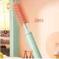 Pink electric bottle brush with rotating silicone head for cleaning baby bottles and pacifiers