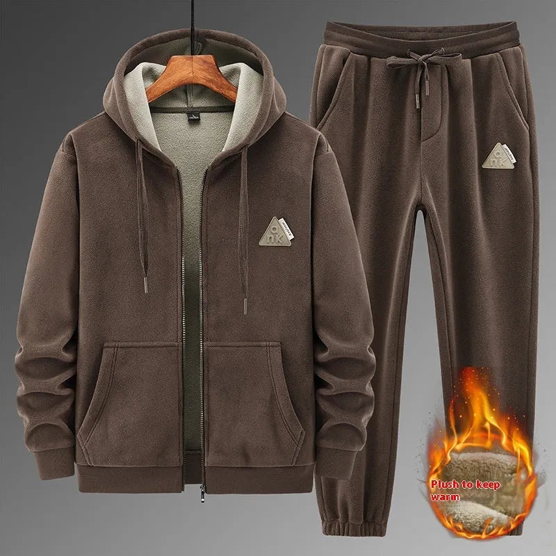 Man wearing a grey hooded cashmere-blend sweater and matching cotton-blend trousers casual sports suit.