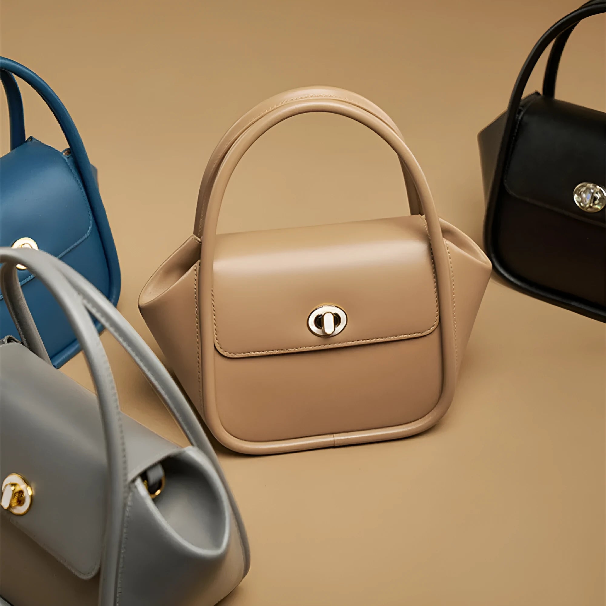 Women's cow leather wing tote bag with shoulder strap and latch closure in four colour options