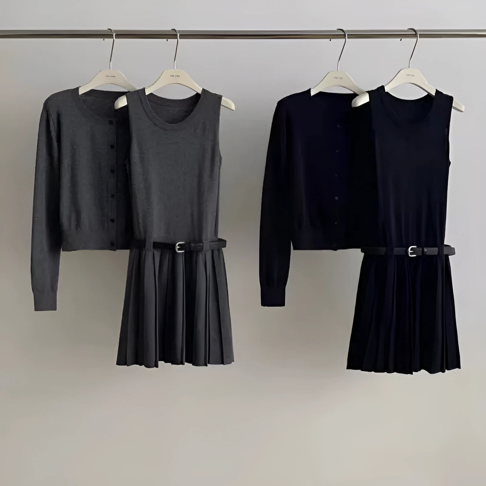 Women's grey art retro knitted cardigan and pleated vest skirt set with a belt.