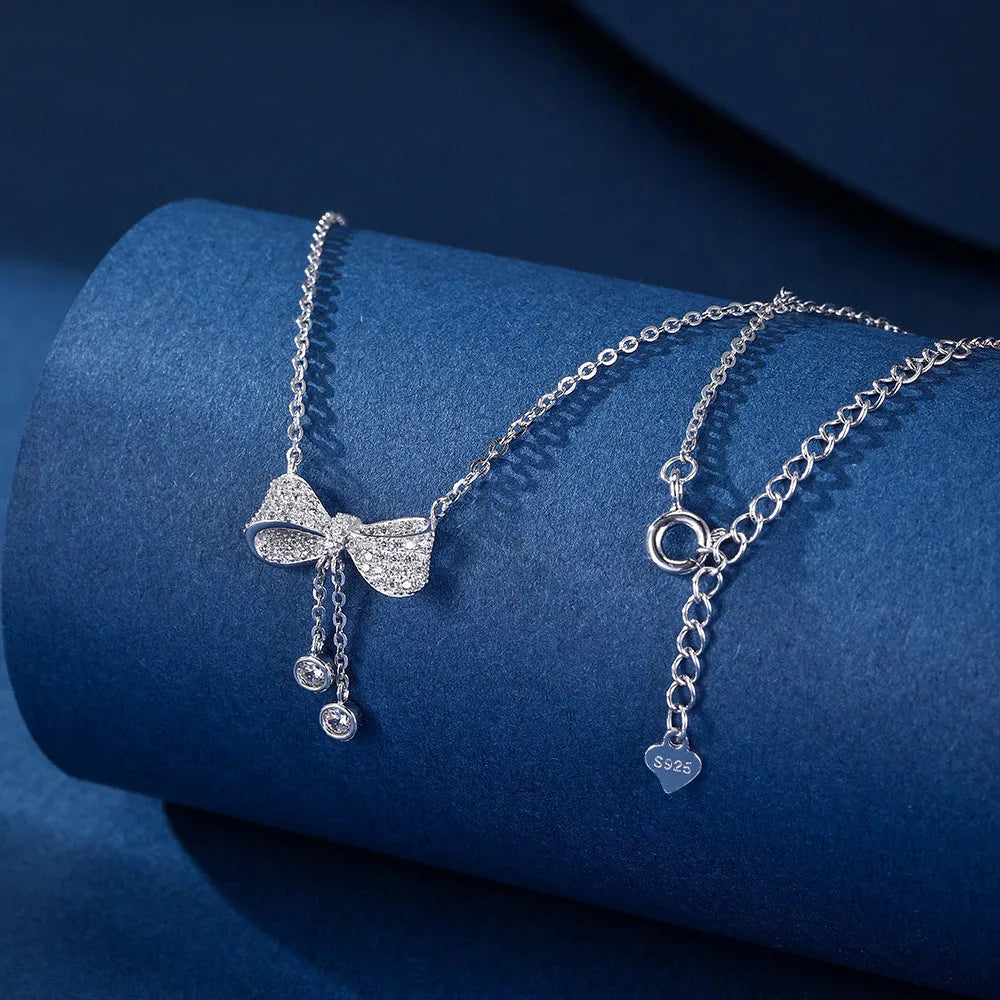 S925 sterling silver necklace with a bow pendant on an O-ring chain.