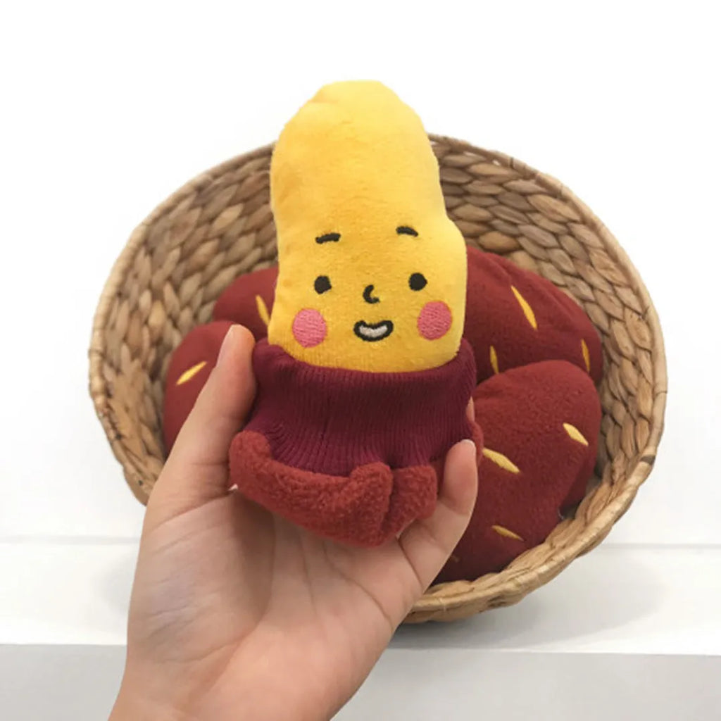 Red sweet potato dog puzzle toy with removable peel showing internal treat pockets