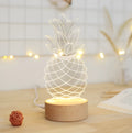 Cartoon pineapple-shaped bedside table lamp with wood base and acrylic shade, showing dimmer buttons.