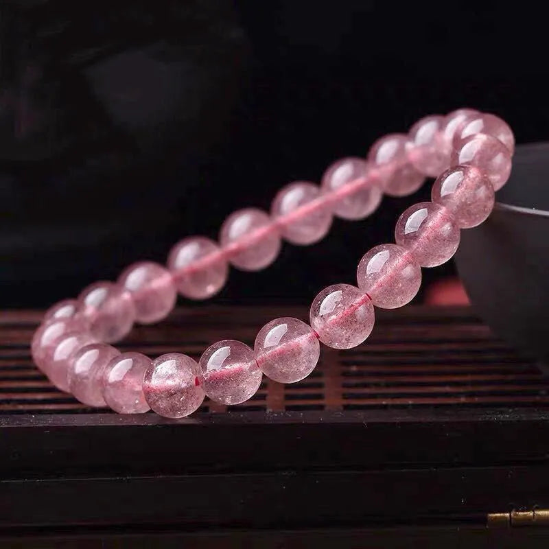 Women's strawberry quartz bracelet showing three bead size options: 6mm, 8mm, and 10mm polished crystal beads.