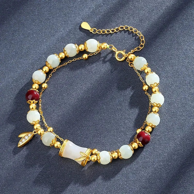 Bamboo style bracelet with electroplated coloured glass beads in a Ruyi flower design.