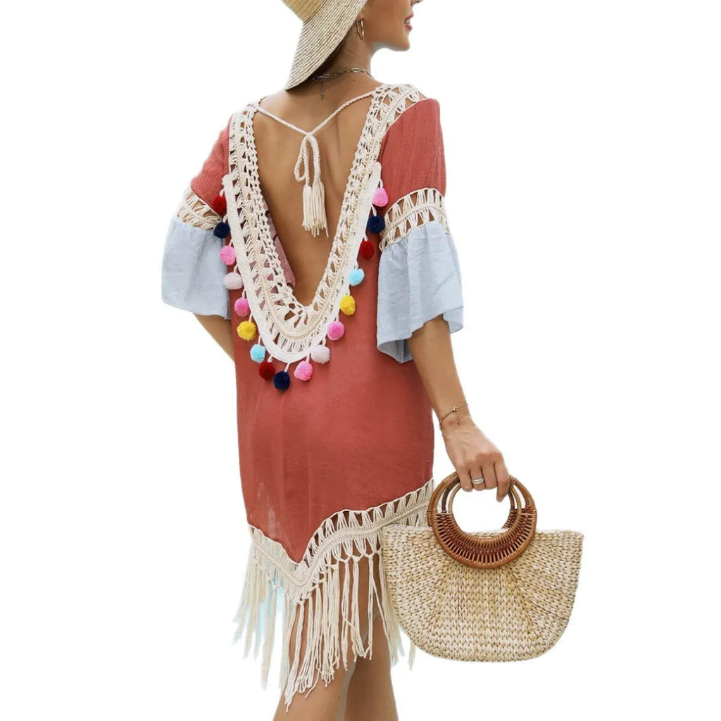 Orange hand-crochet beach overskirt with floral pattern and tassels, part of a matching set