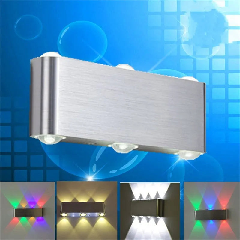 Silver aluminium rectangular LED wall lamp showing seven colour lighting options on bedroom wall