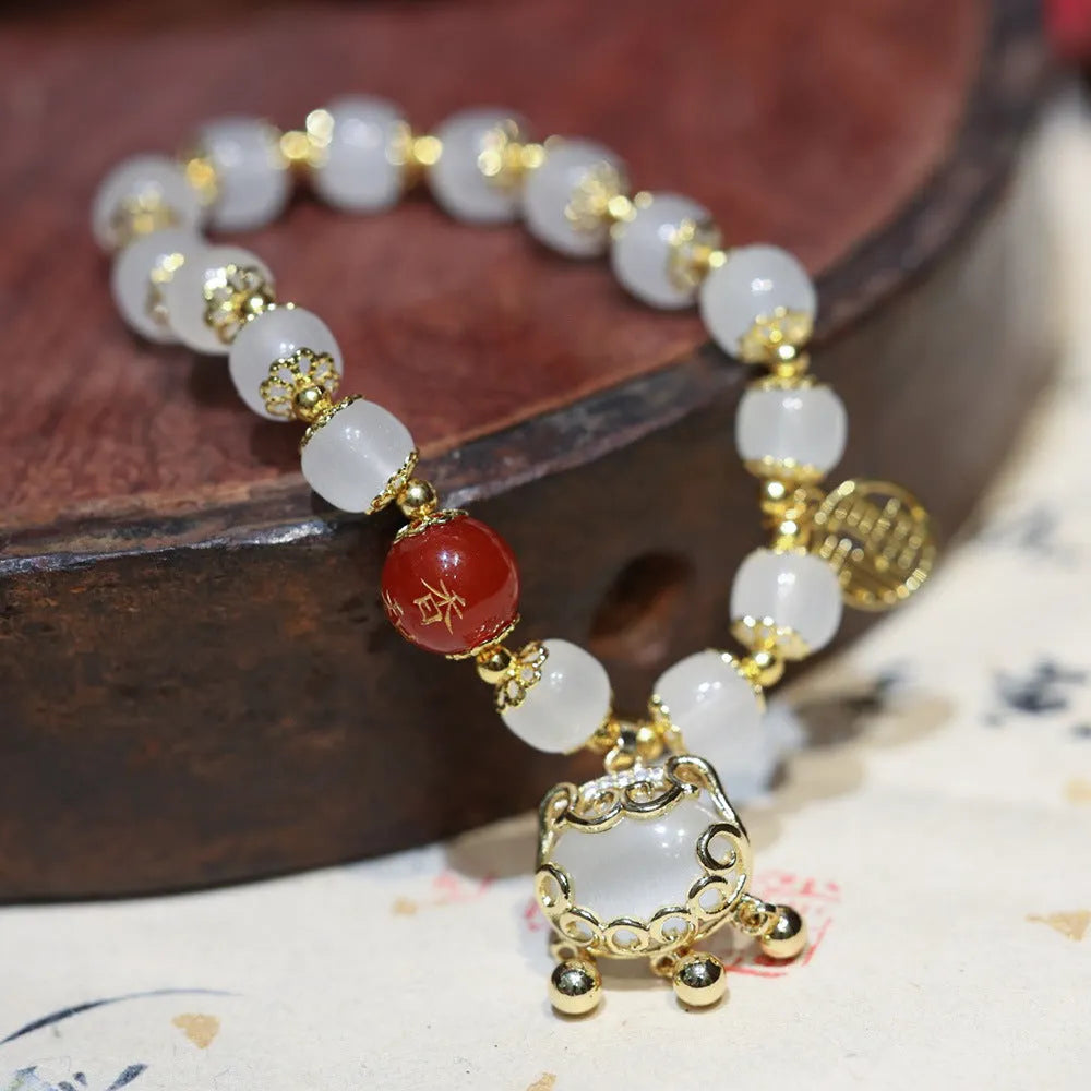 Chinese style women's glass bracelet with fu character and safety lock charms.