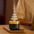 White cloud-shaped ultrasonic humidifier and essential oil diffuser with colourful LED light on base.
