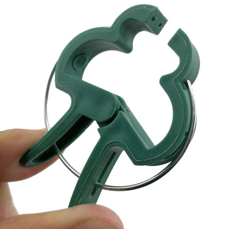 Green plastic and zinc plant fixing clips, showing large and small sizes for climbing vegetables.