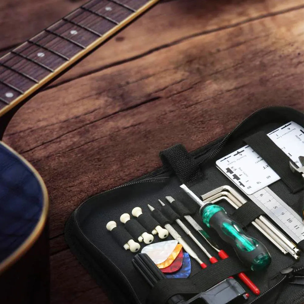 Black plastic case open to reveal metal guitar repair tools for maintenance of guitars, basses, mandolins, and banjos.