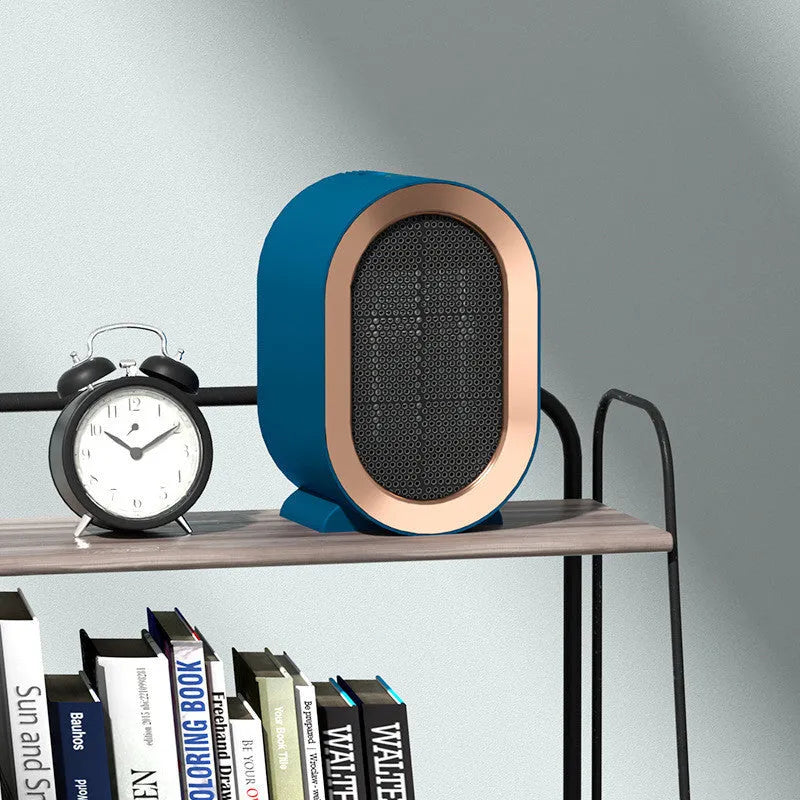 Compact black desktop ceramic fan heater with mechanical control dials and a choice of international power plugs.