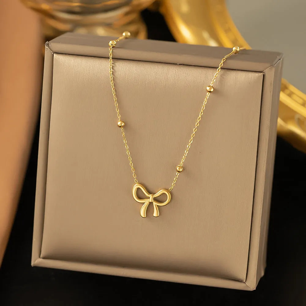 Gold bow necklace on adjustable 41-50cm titanium steel chain with cross link design