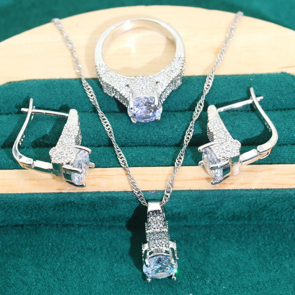 Four-piece bridal zircon jewellery set showing necklace with water wave chain, bracelet, earrings, and ring in alloy with coloured zircon stones