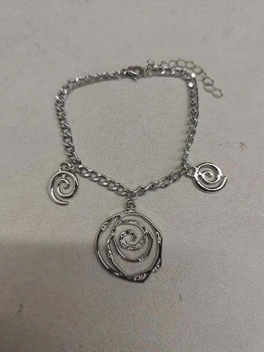 Spiral donut jewellery set showing necklace, bracelet and ear hooks with geometric circle design
