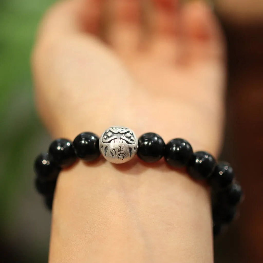 Handmade black agate bead bracelet with sterling silver on a wrist