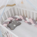 Bendable baby crib bumper pillow in spandex velvet, shown in a light grey colour wrapped around crib rails.
