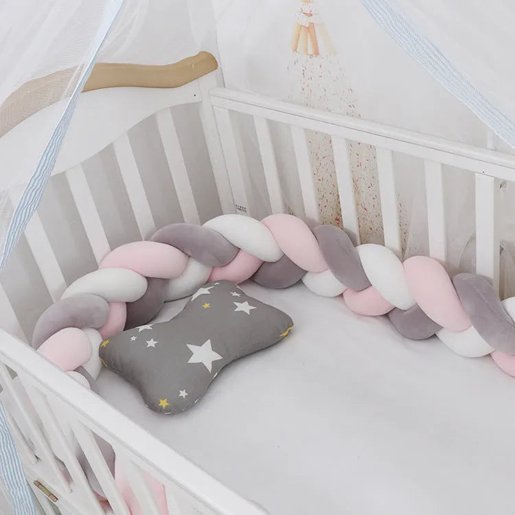 Bendable baby crib bumper pillow in spandex velvet, shown in a light grey colour wrapped around crib rails.