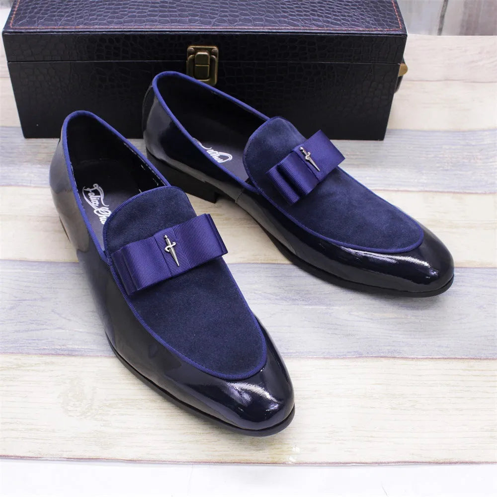 Men's black patent leather low-top dress shoes with a tassel detail on a rubber sole.