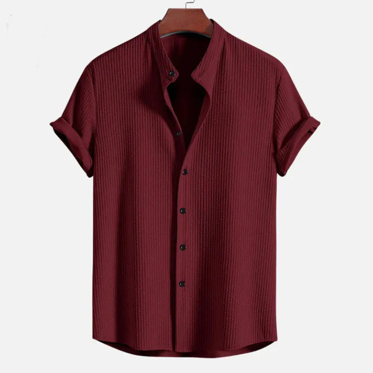 Men's loose fit short sleeve casual shirt in light blue, showing front view on a hanger.