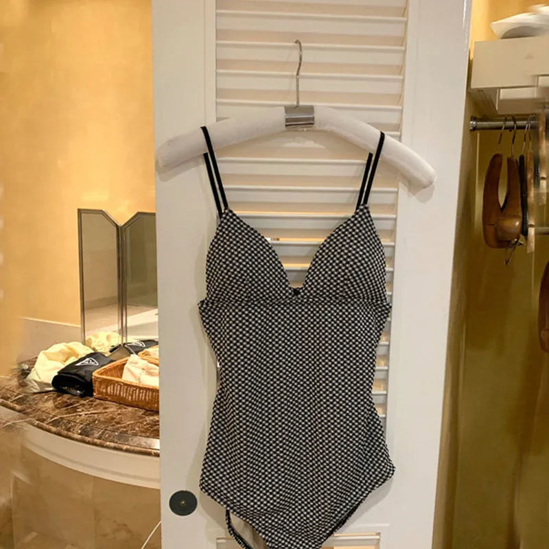 Blue one-piece swimsuit for women with belly coverage design on a mannequin.