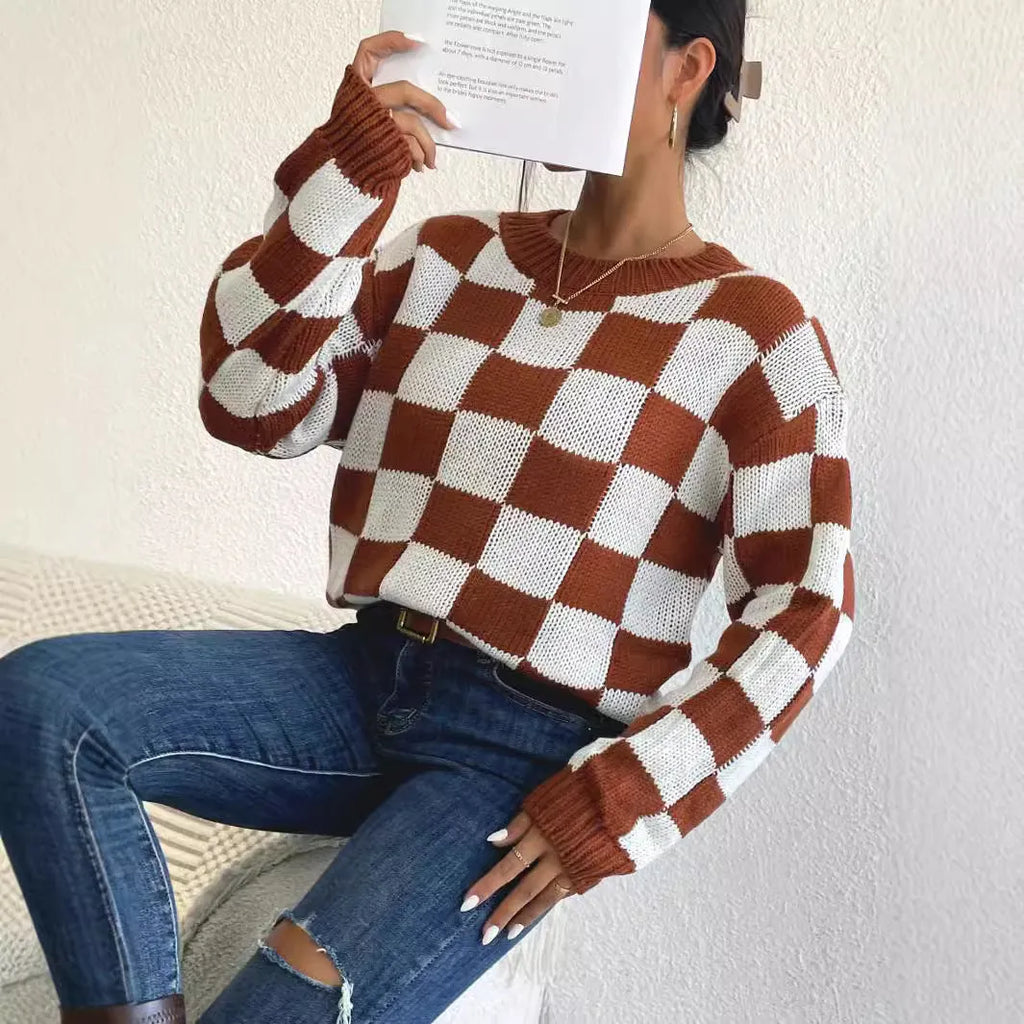 Dark brown loose plaid pullover sweater with a chessboard pattern and long sleeves.
