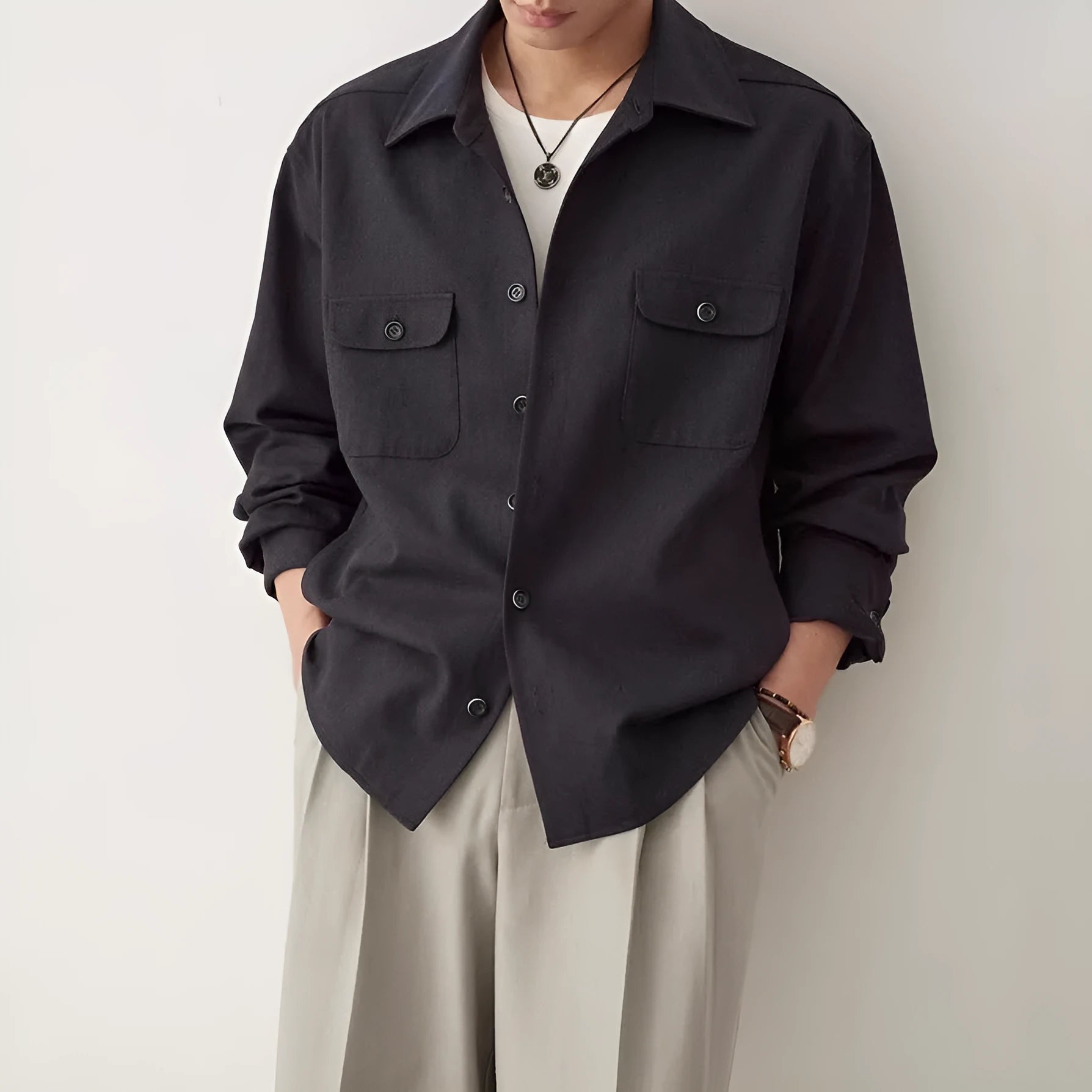 Men's light sand rice coloured long sleeve shirt with a simple lapel collar on a hanger.