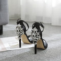 Black suede women's high heels with rhinestone decoration and a fish mouth open toe.