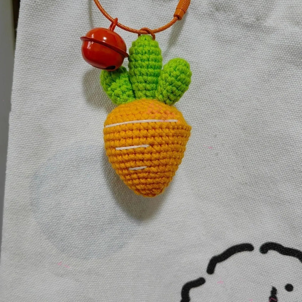 Soft wool cartoon carrot shaped keychain pendant on a keyring.