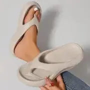 Black women's flip-flops with thick sole and textured non-slip tread.