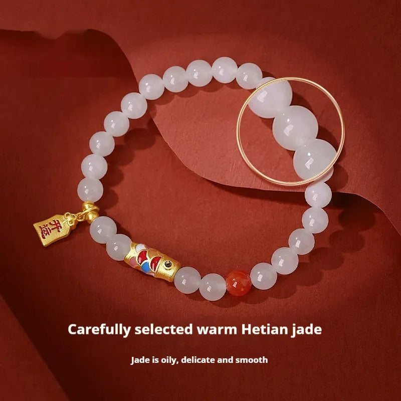 S925 sterling silver bracelet with a 6mm Hetian jade bead and a detailed cold enamel koi fish charm.