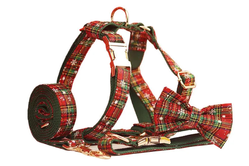 Green fabric Christmas pet collar and leash set with snowflake pattern, including a vest and decorative bow.