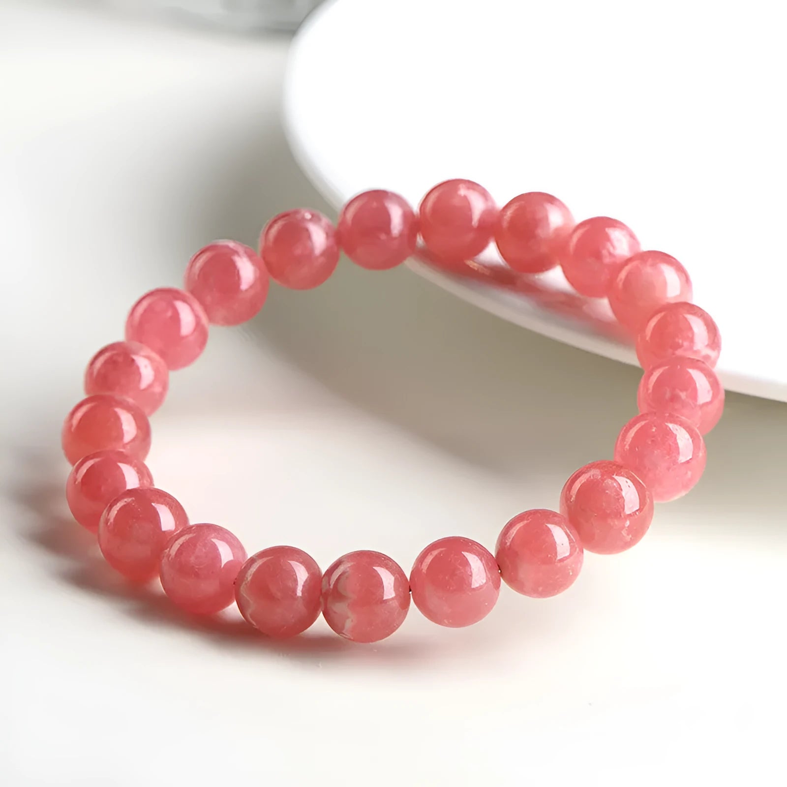 Women's geometric rhodochrosite crystal bracelet with longevity lock clasp in natural red patterned stone