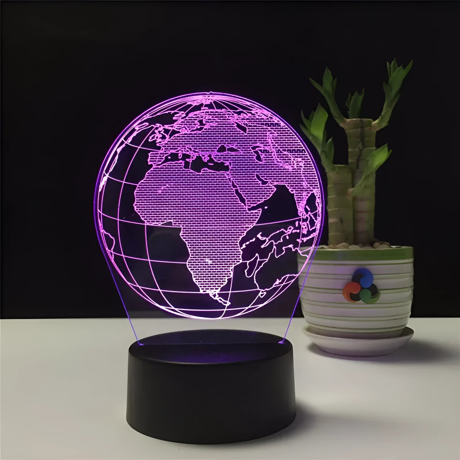 3D Earth globe USB night light on a desk showing seven colour modes with remote control