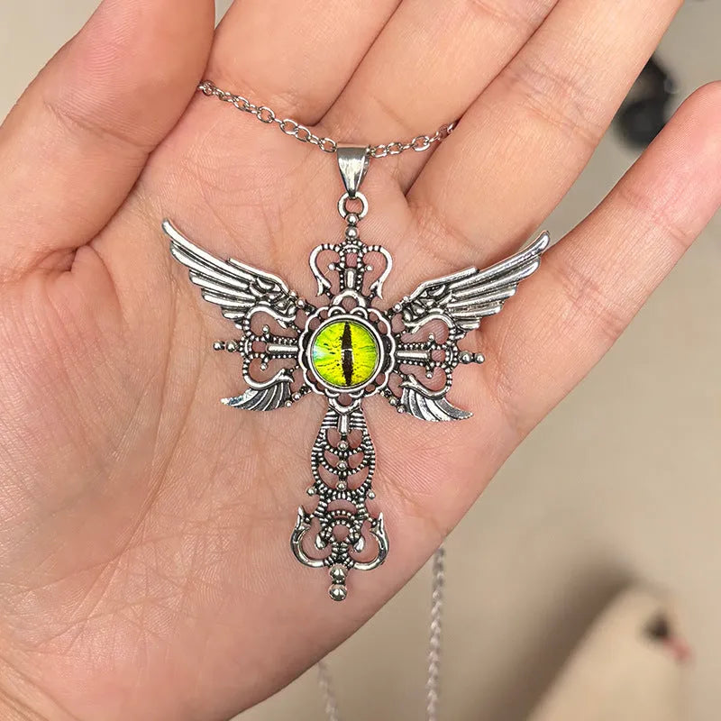 Close-up of a colourful alloy necklace featuring a geometric pendant with devil wings and a cross design.