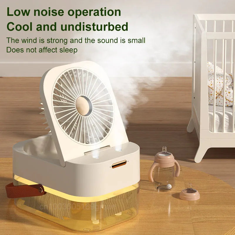 White desktop mist fan with humidifier tank and remote control on a wooden desk.