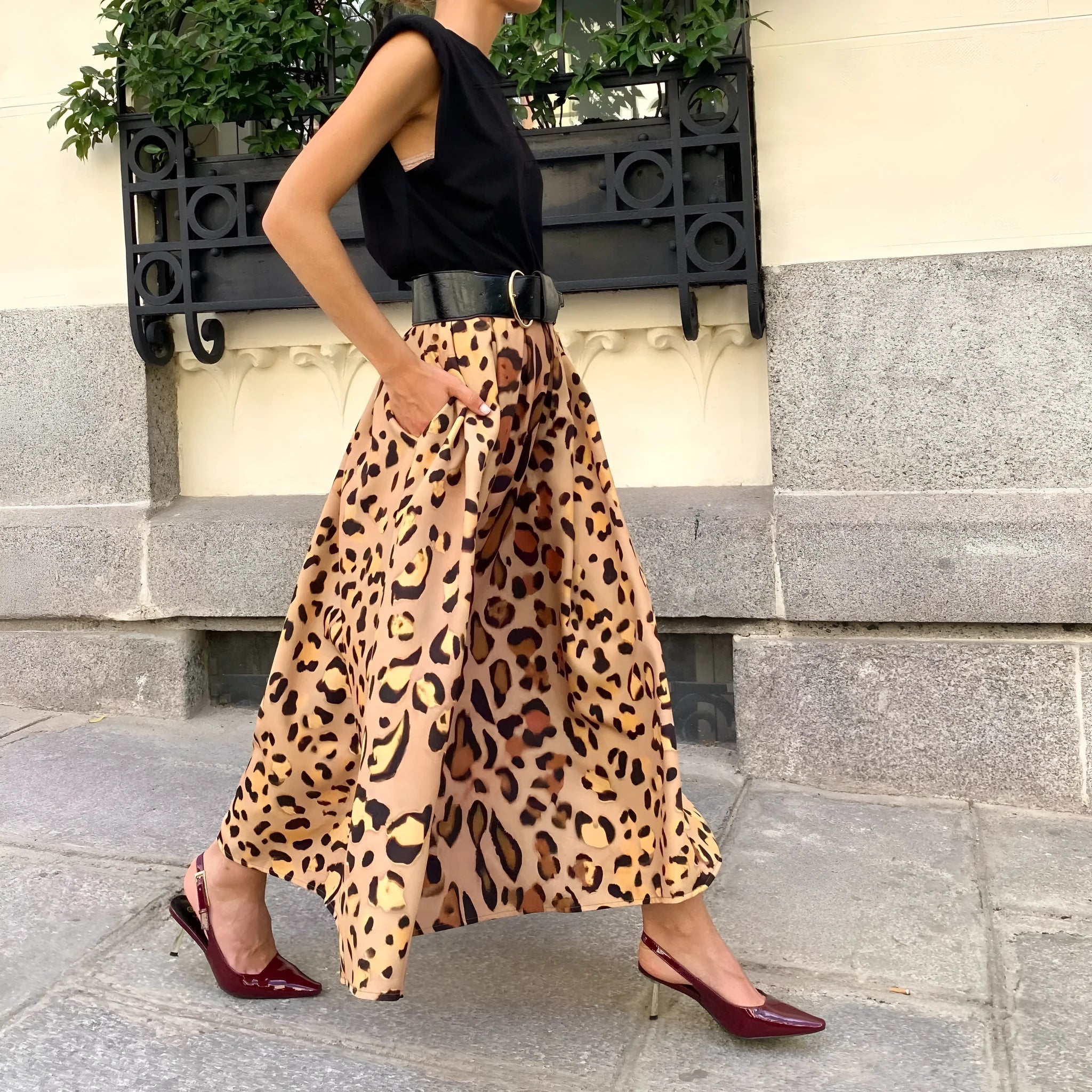 Women's brown leopard print A-line long skirt with a big hem on a hanger.