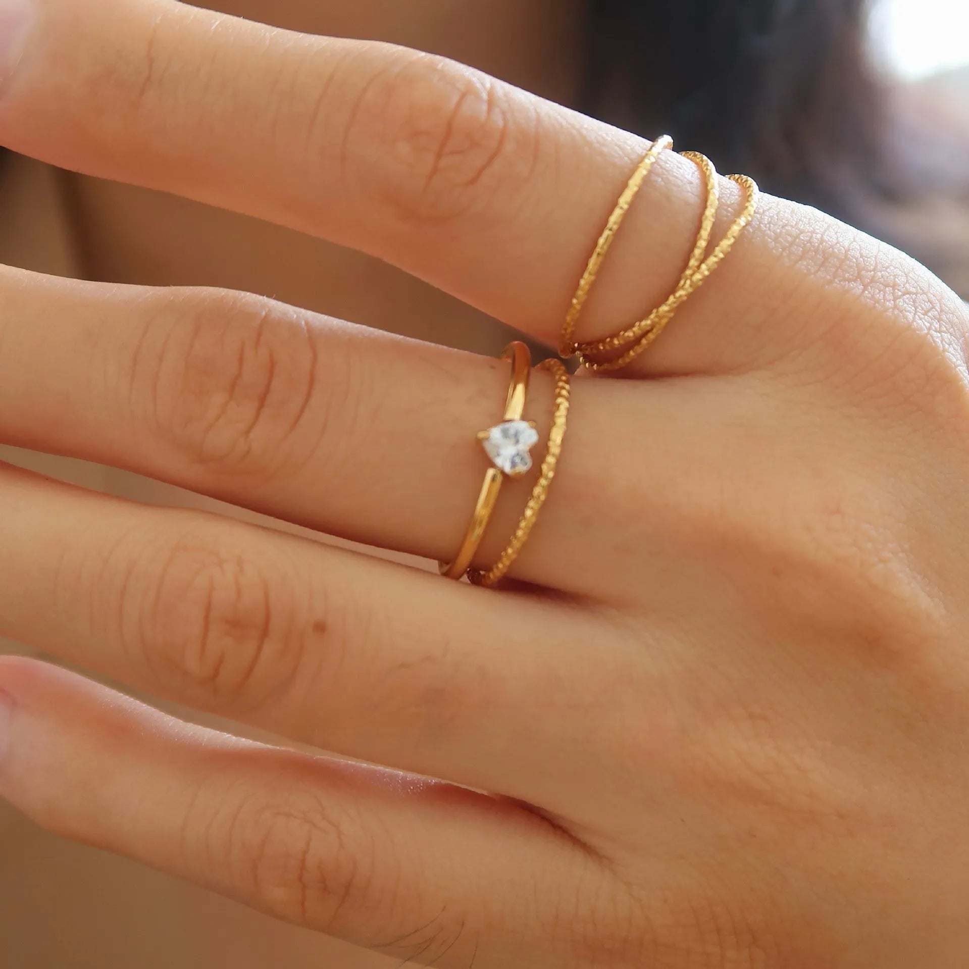 Golden electroplated stainless steel ring showing love heart and oval shapes in sizes no.5 to no.8