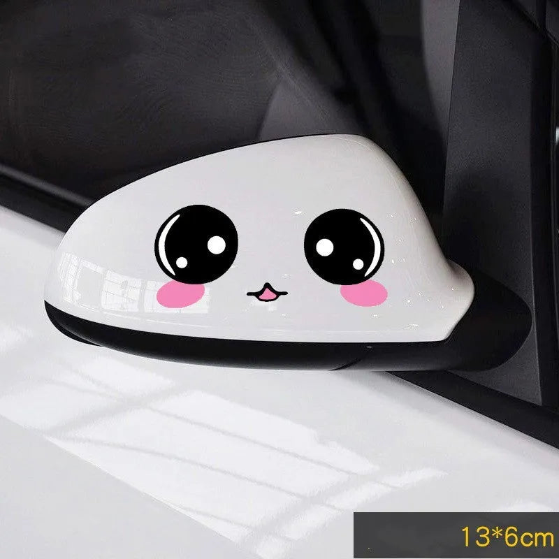 Pair of reflective cartoon car stickers with cute eye designs on a white background.