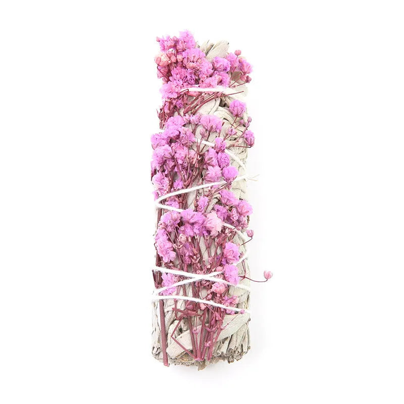 White sage and red rose petal colourful aromatherapy incense bundle on a wooden table