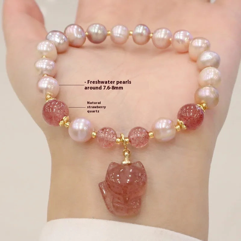 Women's light pink freshwater pearl bracelet with strawberry quartz beads and a small fox charm on an adjustable cord.