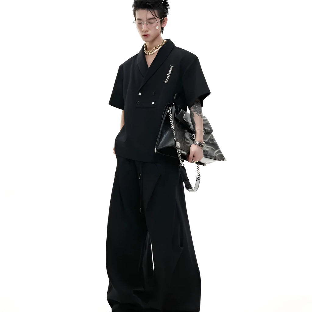 Men's dark grey V-neck cotton sports jacket with padded shoulders and metal details, paired with matching shorts.