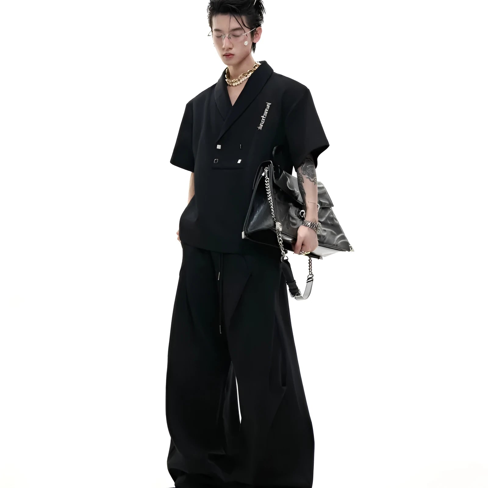 Men's dark grey V-neck cotton sports jacket with padded shoulders and metal details, paired with matching shorts.