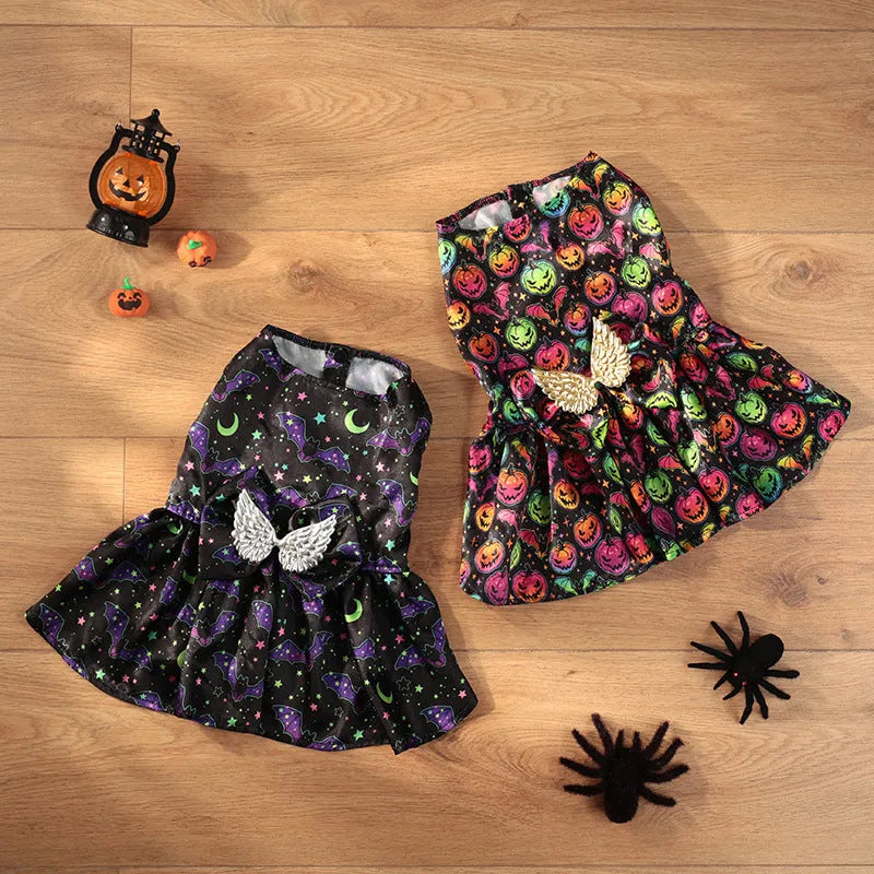 Angel wings Halloween dog costume with bright pumpkin design shown on small dog