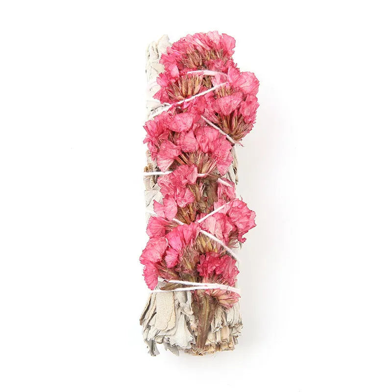 White sage and red rose petal colourful aromatherapy incense bundle on a wooden table