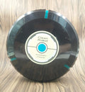 Black or white AC-powered robot vacuum cleaner on a wooden floor.