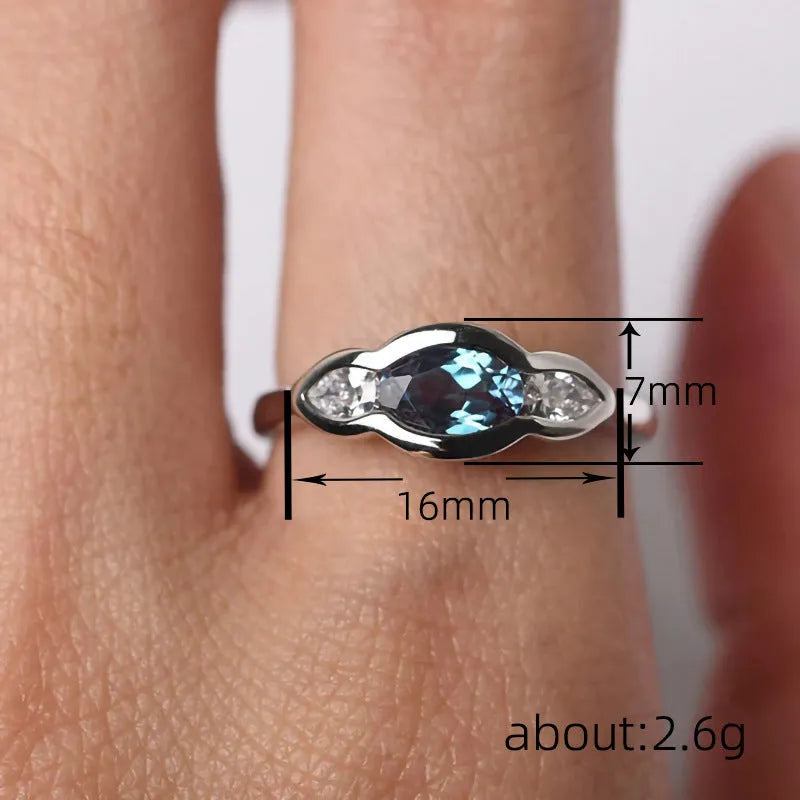 Geometric ellipse women's ring with zircon inlay in white gold finish, showing sizes 6 to 10